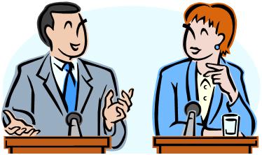 Two debaters at podiums smile at one another