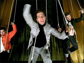 Members of the band 'N Sync hang from strings in a still from the "Bye Bye Bye" music video.